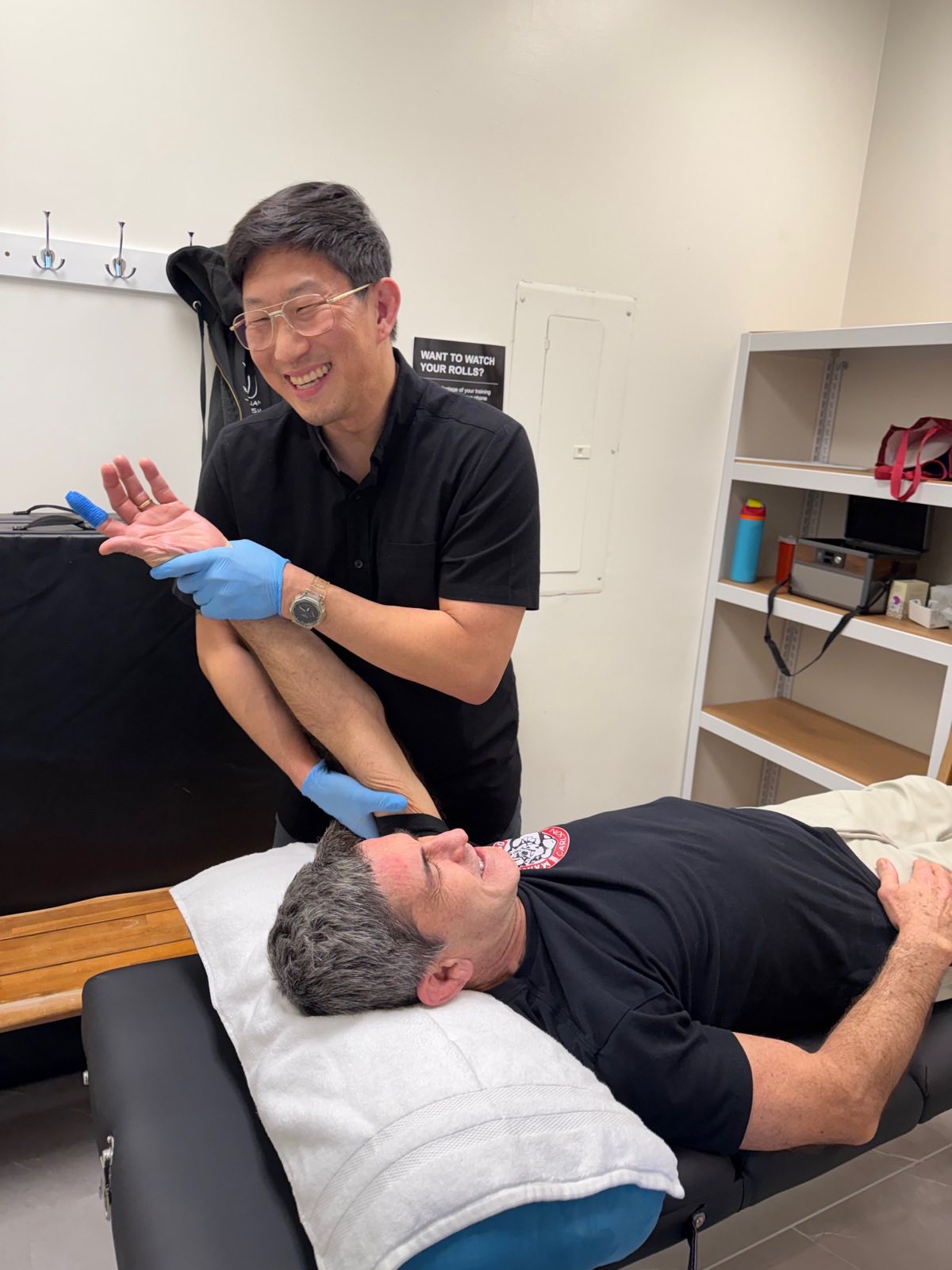 Brian working on a patient's hand and wrist during a treatment session