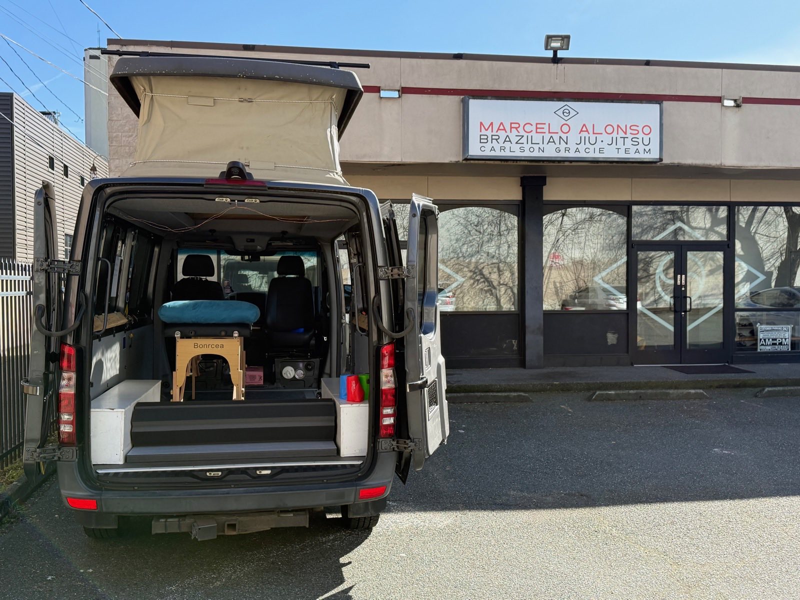 The Roll Ready PT pop-up van parked outside a Brazilian Jiu-Jitsu academy