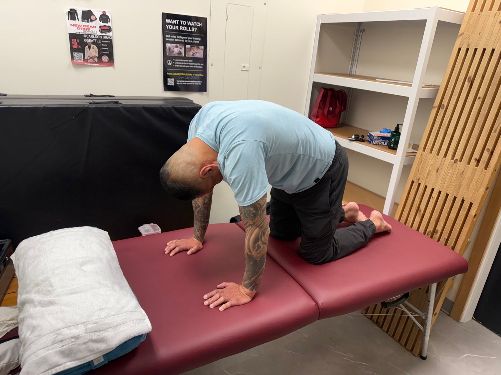 A patient performing a guided mobility exercise on a treatment table