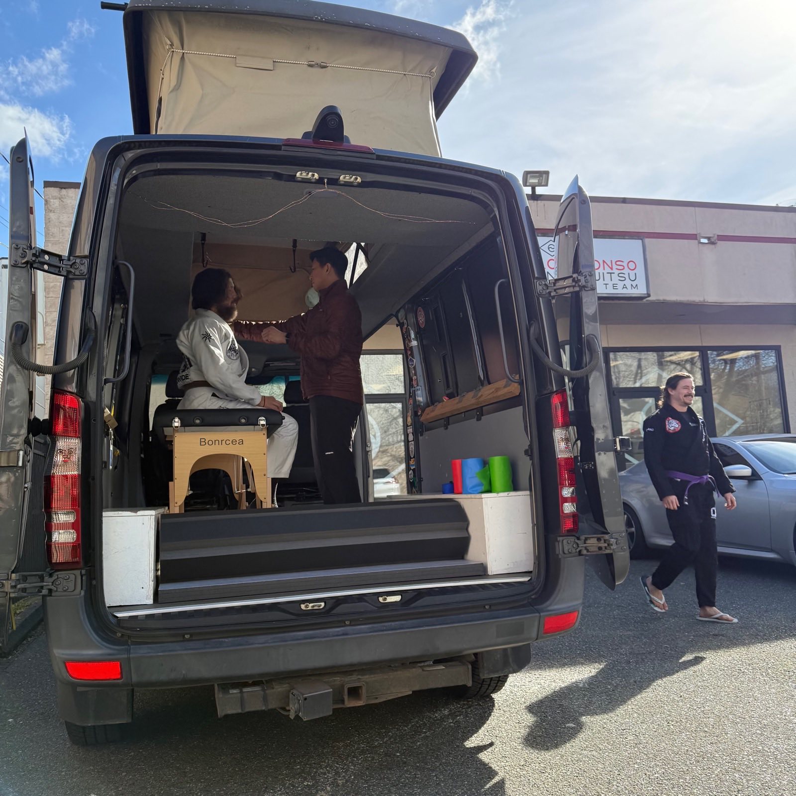 Brian treating a patient inside the pop-up van between classes